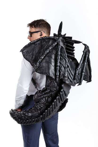 Leather dragon-backpack hugging you,  LUMINESCENT PATTERN, dragon tail wraps your waist, puts paws on shoulders, covers your shoulders wings