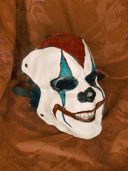 White Leather Mask "Trickster Clown" , with coloring, with five strap-system, red mouth, blue diamonds eyes outline, black normal nose.