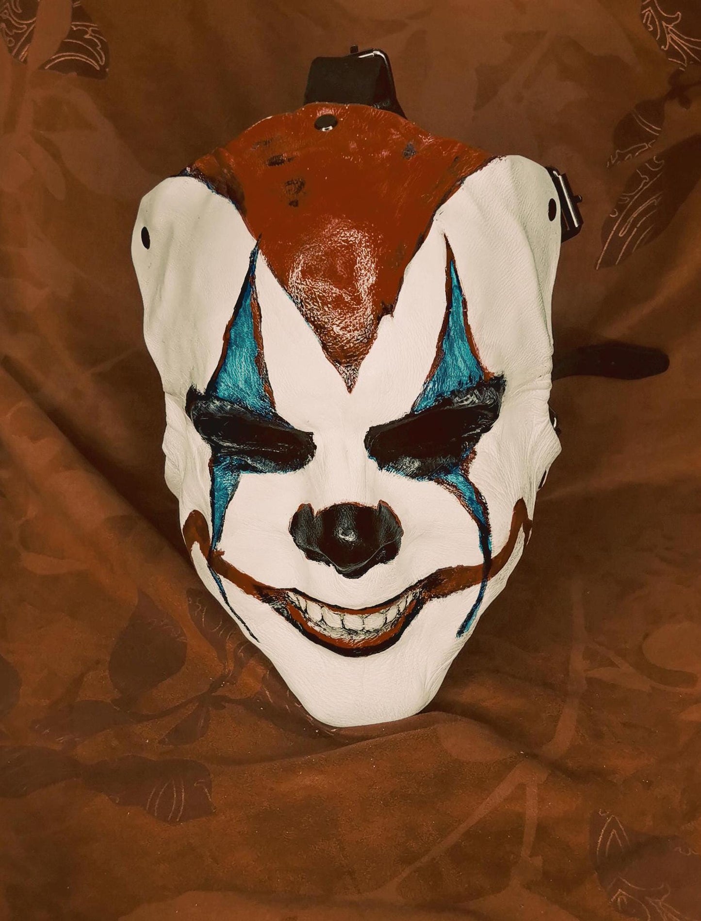 White Leather Mask "Trickster Clown" , with coloring, with five strap-system, red mouth, blue diamonds eyes outline, black normal nose.